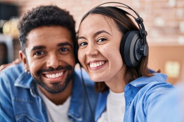 Sticker - Man and woman musicians listening to music make selfie by camera at music studio