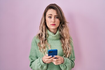 Sticker - Young caucasian woman using smartphone typing message skeptic and nervous, frowning upset because of problem. negative person.