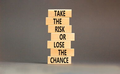 Wall Mural - Risk or chance symbol. Concept words Take the risk or lose the chance on wooden blocks. Beautiful grey table grey background. Copy space. Motivational business risk or chance concept.