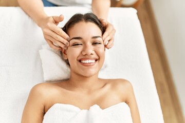 Poster - Young latin woman relaxed having face massage at beauty center