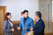 © Niks Ads - Indian senior businessman discussing with young managers or partners.