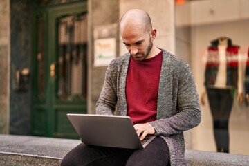 Sticker - Young man using laptop sitting on bench at street