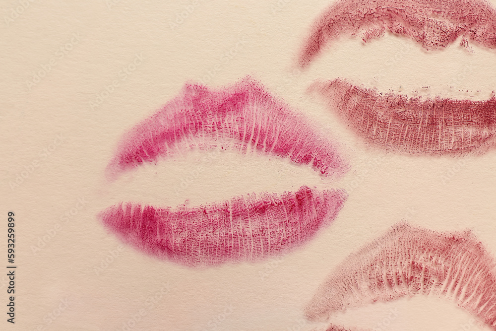 Lipstick kiss marks on beige background