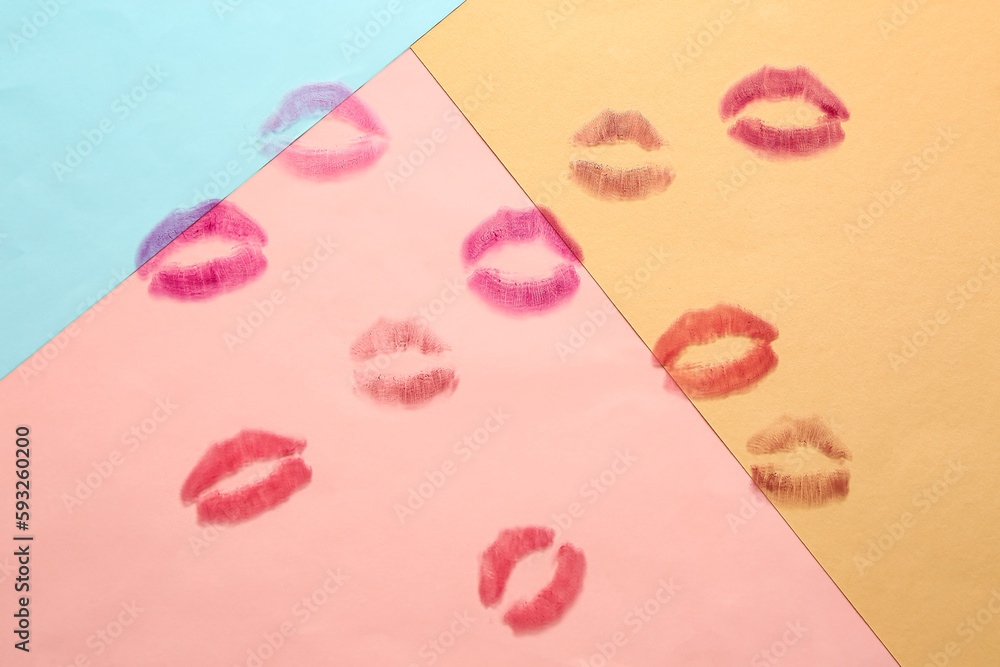 Lipstick kiss marks on color background