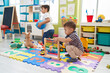 © Krakenimages.com - Adorable boys playing with abacus and ball at kindergarten