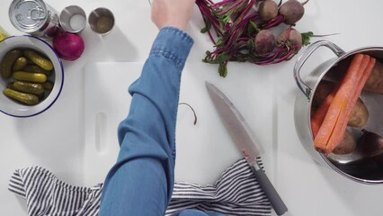 Wall Mural - Flat lay. Step by step. Cutting cookies vegetables on a white cutting board for vinaigrette salad.