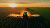 Fototapeta  - A tractor sprays an agricultural field with fertilizer on a sunset evening. Drone view. Illustration by Generative AI.