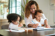© tonefotografia - African American mother playing with her daughters in home
