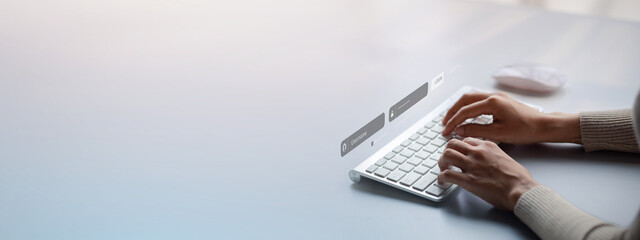 An individual is typing on a laptop keyboard showing a hologram interface to a member login, a businessman is going to access the company's membership system, check the information of the parties.