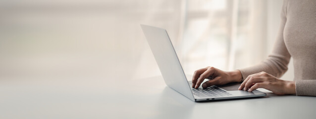 person typing on laptop keyboard, businessman working on laptop, he is typing messages to colleagues