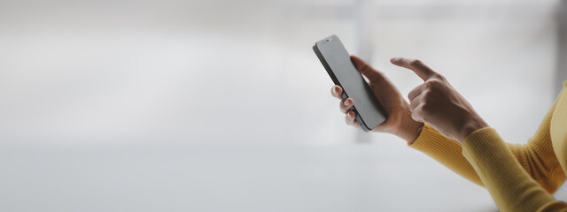 A person holds a mobile phone to use social media on a smartphone, communicating via the Internet on a smartphone. The concept of using technology in communication.