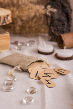 Handmade Cardboard Scandinavian Runes In A Bag On A Divination Table Vertical View