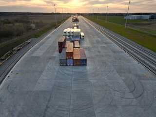 Wall Mural - Cargo train terminal with freight train containers during sunset. Business import export logistic and transportation railway.