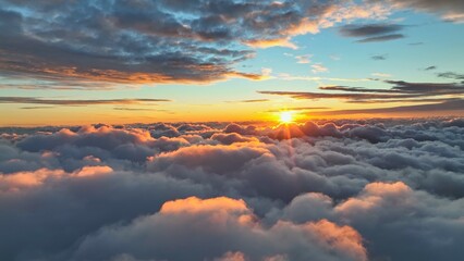 sun goes into the clouds. epic sunset in the sky, aerial shot. flying above the clouds illuminated b