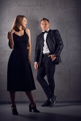 Stylish couple in trendy clothes in studio