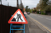 Temporary Triangular Sign Warning Of Roadworks Streetworks Construction Ahead.