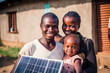 © VisualProduction - Young African American family holding a small solar panel, building their own solar plant. Generative ai.