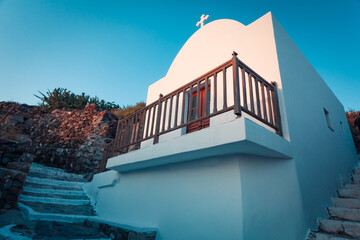 mall white chapel in Plaka town on Milos island in Greece in sunset light