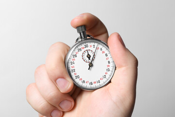 Wall Mural - Man holding vintage timer on white background, closeup