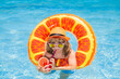 © Volodymyr - Child in sunglasses and summer hat drink summer cocktail and floating in pool. Kids summer vacation. Children floating in water pool. Children playing and active leisure, swimming pool concept.