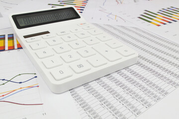 Wall Mural - White modern calculator on financial documents and data, wide angle image. Concept of business, calculating, planning and accounting.