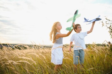 Wall Mural - children play toy airplane. concept of happy childhood. children dream of flying and becoming a pilot.