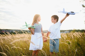 Wall Mural - children play toy airplane. concept of happy childhood. children dream of flying and becoming a pilot.