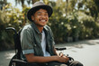 African american young man in wheelchair outdoors smiling. Generate by ai