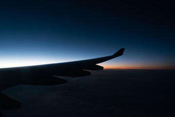 Wing of a airplane at sunrise at an altitude of 11 km.