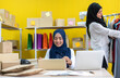 © Art_Photo - Muslim two asian woman freelancer sme business online shopping working and checklist order with cardboard box on table at home - Business online shipping and delivery concept