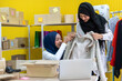 © Art_Photo - Muslim two asian woman freelancer sme business online shopping working and checklist order with cardboard box on table at home - Business online shipping and delivery concept