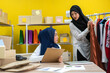 © Art_Photo - Muslim two asian woman freelancer sme business online shopping working and checklist order with cardboard box on table at home - Business online shipping and delivery concept