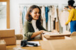 © (JLco) Julia Amaral - Business woman preparing orders for drop shipping in her clothing boutique