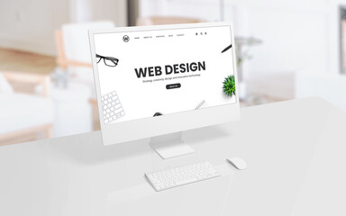 Poster - White computer display on an office or studio desk with a web design concept web page on the screen. Modern technology, creative design, and productivity concept