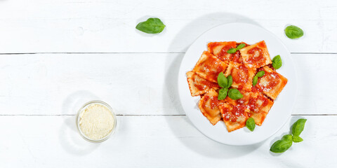 Ravioli pasta meal from Italy for lunch dish with tomato sauce top view on a plate and wooden board copyspace copy space