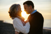 Mature Man And Woman Embracing Each Other At Sunrise