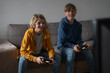 © Westend61 - Friends playing video game at home