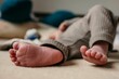 © Stefan Radosavljevic/Wirestock Creators - Closeup shot of the bare toes of the newborn baby