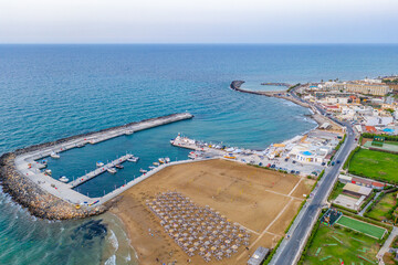 Wall Mural - Marina Port Gouves - late afternno drone aerial photo, city landscape, buildings and blue water anb sandy beach