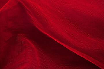 Dark elegant wallpaper made of red tulle fabric. Aesthetic fashion, passion and love background.