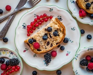 Sticker - Overhead shot of a slice of bread and colorful berries on a dainty ceramic saucer