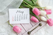 May calendar and tulips bouquet