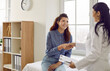 © Studio Romantic - Smiling doctor and patient exchange handshakes. Cheerful beautiful young woman meeting with a general practitioner. Happy, friendly nurse or physician shaking hands with her female patient