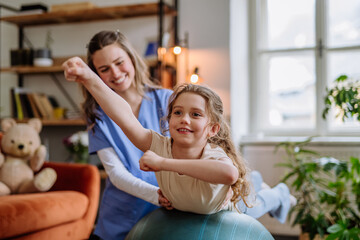 Little girl doing exercise with a nurse.