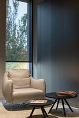 Poster - Interior design with roller blinds in the background. Solar shades on the window. Sunscreen fabric black color. In front of the window is an armchair on a carpet. Selective fokus.