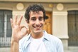 © Asier - Young handsome caucasian man at outdoor cheerful and confident showing ok gesture.