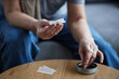 © Seventyfour - Unrecognizable adult woman rolling cigarette for therapeutic purpose and medical treatment, copy space
