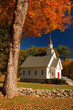 Autumn leaves,, a stone wall and a charming village chapel and church are the hallmarks of a New England fall scene