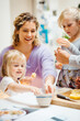 © Melissa Milis Photography/Stocksy - family making food in the kitchen