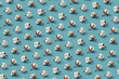 © Yaroslav Danylchenko/Stocksy - Tender cotton pattern against blue background.
